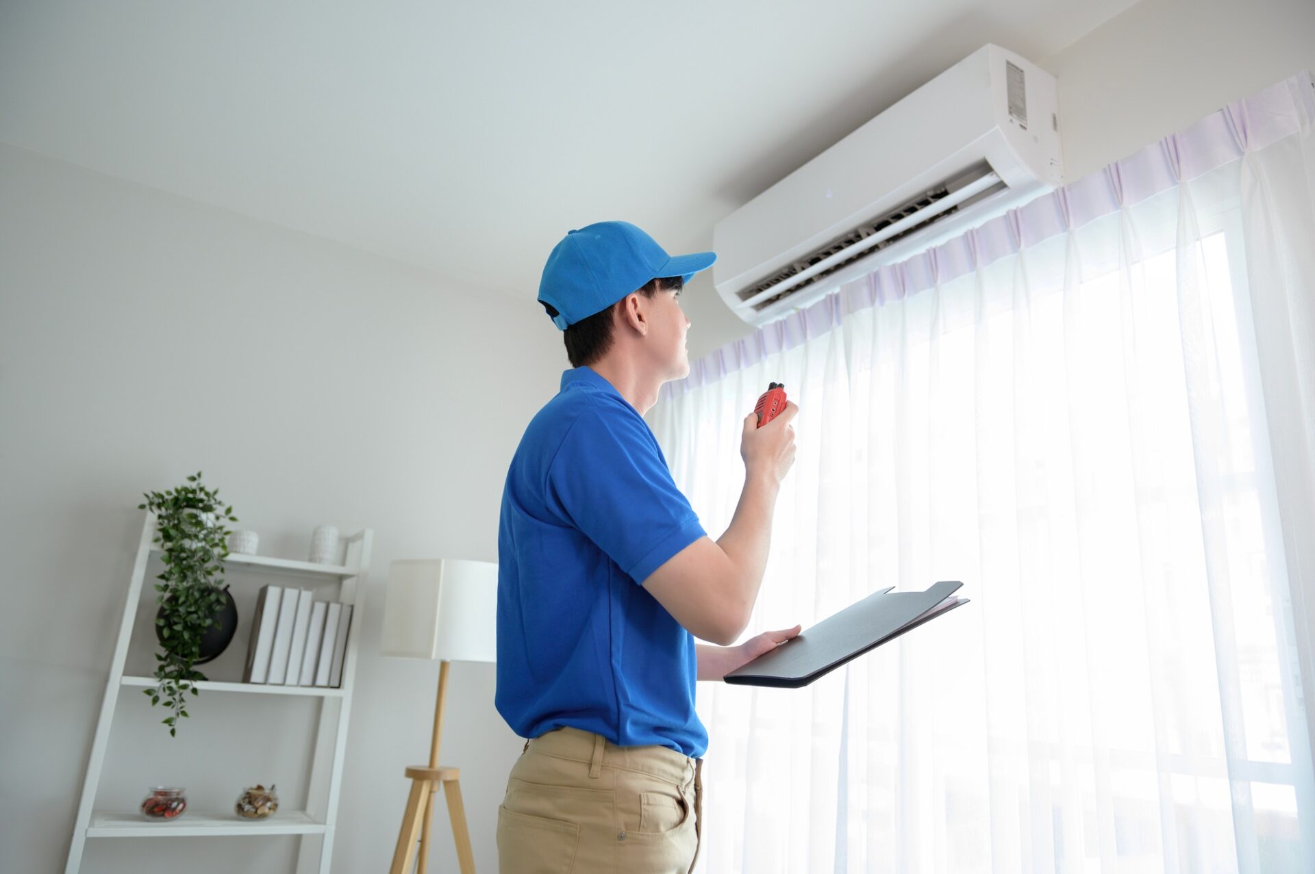 Technician service man checking air conditioner