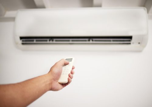 Air conditioner, hand and electrical machine check with person in a home with ac repair. Maintenanc