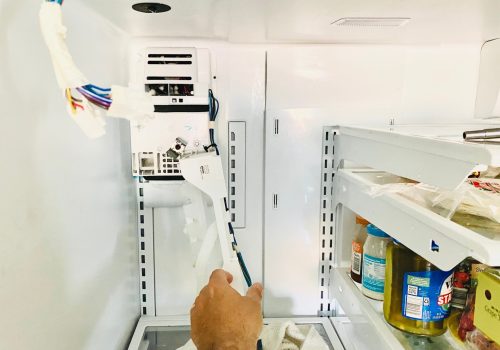 fixing-a-broken-ice-maker-in-a-refrigerator.jpg