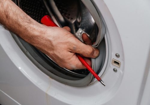 handyman-repairing-a-washing-machine-the-hands-of-a-man-repair-a-washing-machine-.jpg